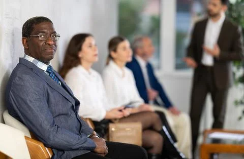 Applicants are waiting for interview, there is queue of people sitting in Stock Photos