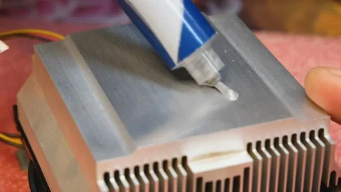 Application and distribution of thermal paste from a tube to a PC cooling Stock Footage 143903405