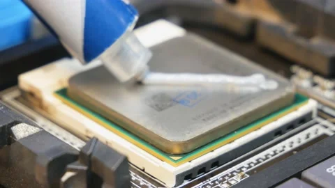 Application and distribution of thermal paste from a tube to the main processor Stock Footage 144095233