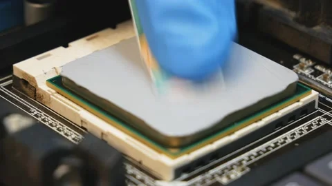 Application and distribution of thermal paste from a tube to the main processor Stock Footage 145848519