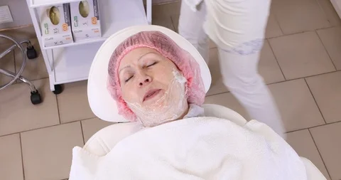 Application of anesthetic cream process to the senior woman Stock Footage 102027950