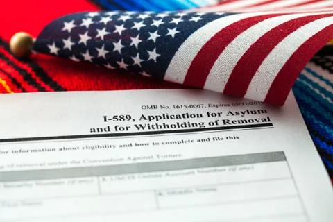 Application for asylum to USA concept with application form and USA flag on m Stock Photos