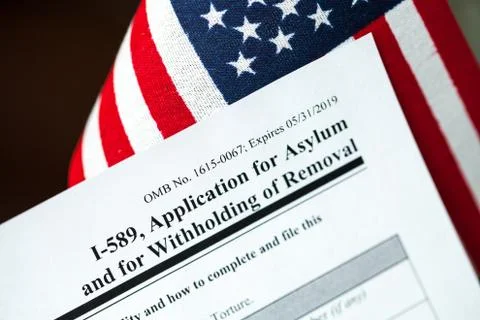 Application for asylum to USA concept with application form and USA flag on m Stock Photos