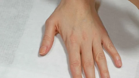Application of base to the nails of the left hand Video stock 106459020