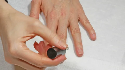 Application of base to the nails of the left hand Video stock 106460079