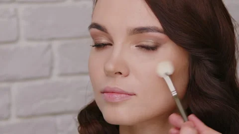 Application of beauty makeup on a model showcasing a beautiful natural Stock Footage 304174479