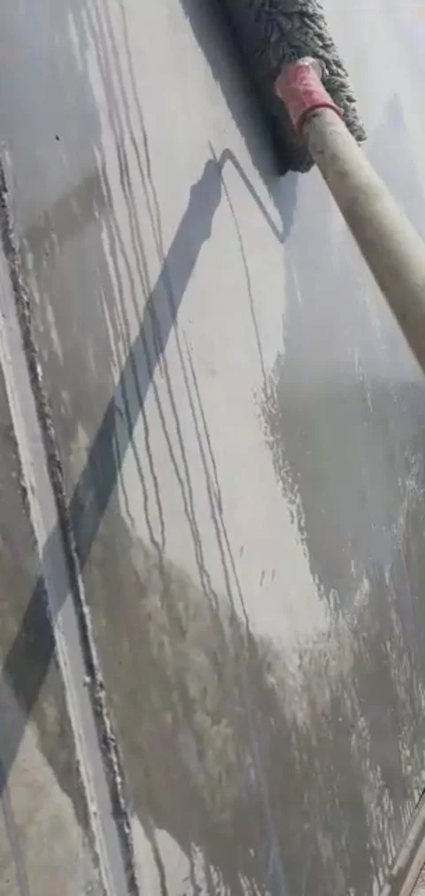 Application of a coat of primer spread with a roller on a concrete wall 스톡 동영상 331339839