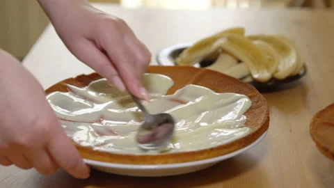 Application of condensed milk on baked cakes Stock Footage 90936005