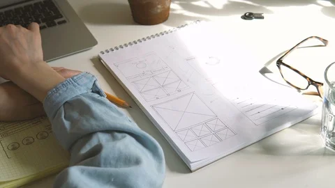 The application developer draws sketches in a notebook. Works remotely from home Video stock 88171316