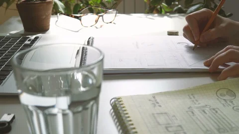The application developer draws sketches in a notebook. Works remotely from home Video stock 88172920
