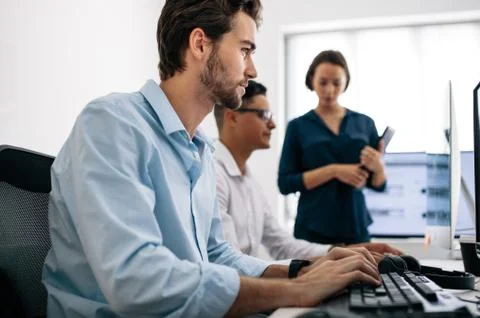 Application developers working on computers in office Foto stock
