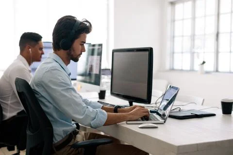Application developers working on computers in office Stock Photos