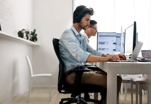 Application developers working on computers in office Stock Photos