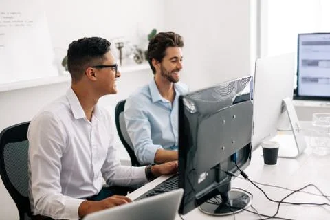 Application developers working on computers in office Stock Photos