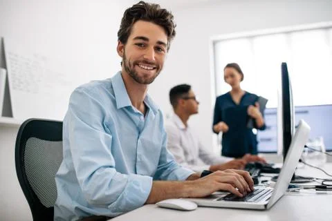 Application developers working on computers in office Stock Photos