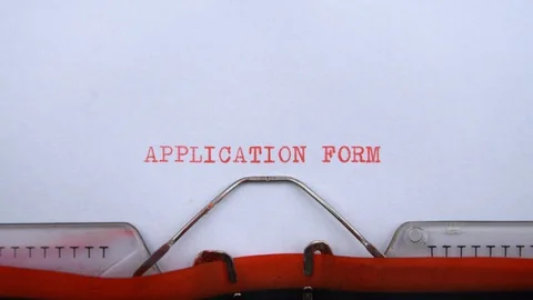 Application form - phrase printed on an old typewriter in red letters, close up. Stock Footage 128400733