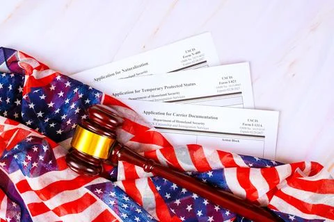 Application forms for immigration processes on an American flag with laws g.. Stock Photos