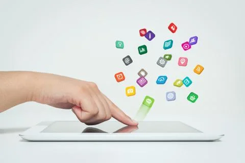 Application icons fly off the tablet computer in hand Stock Photos