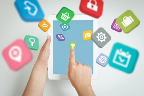 Application icons fly off the tablet computer screen in hand Stock-Fotos