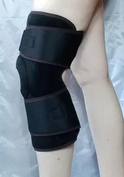 Application of a knee brace. Stock Photos