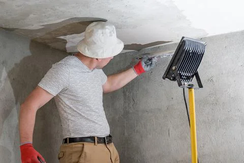 Application of lime plaster on the ceiling, repair work with environmentally  Stock Photos
