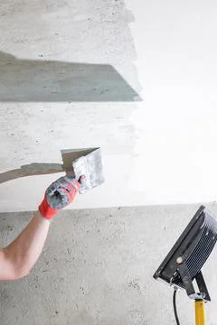 Application of lime plaster on the ceiling, repair work with environmentally  Stock Photos