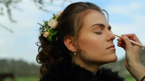 Application make up on bride before stylist wedding during sunny day Video stock 107661159