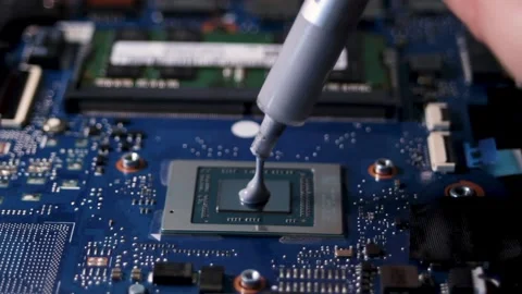 Application of a new thermal paste to the laptop processor. Close-up of the Stock Footage 316087909