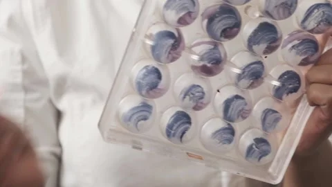 Application of paint on a chocolate mold Stock Footage 132800332