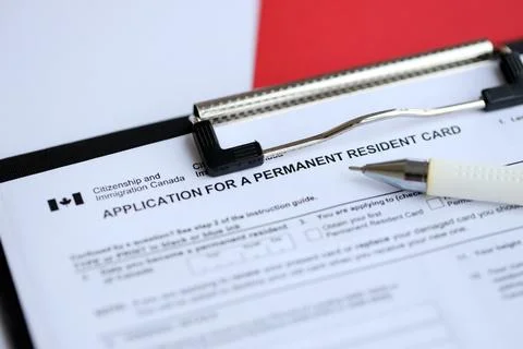 Application for permanent resident card on table with pen Stock Photos