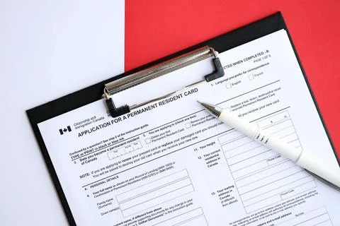 Application for permanent resident card on table with pen Stock Photos