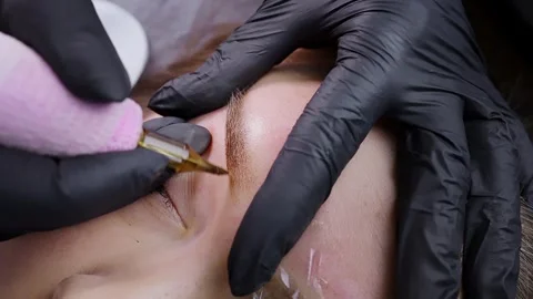 Application of pigment for permanent eyebrow makeup Stock Footage 266399923