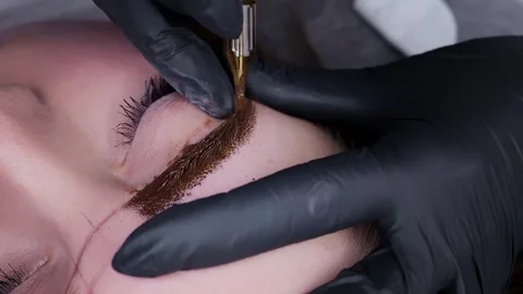Application of pigment for permanent eyebrow makeup Stock Footage 266401110