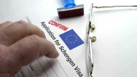 Application for Schengen Visa with confirm stamp and eyeglasses Stock Footage 332725512
