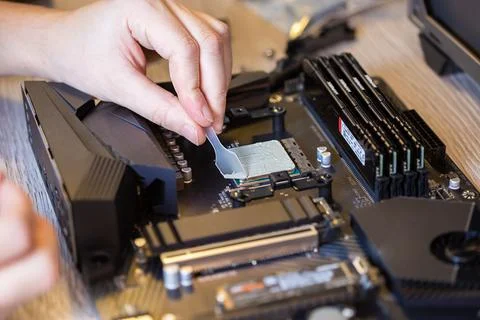 Application Of Thermal Paste On The computer Processor Chip For Cooling. Stock Photos