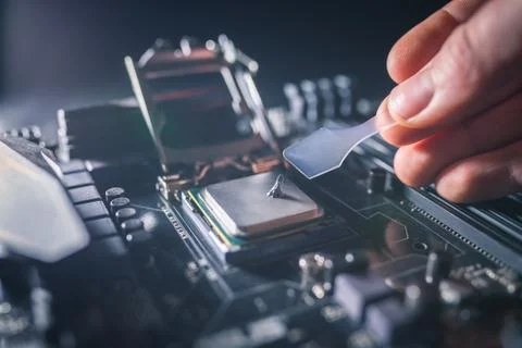 Application of thermal paste on the laptop processor chip for high-quality Stock Photos