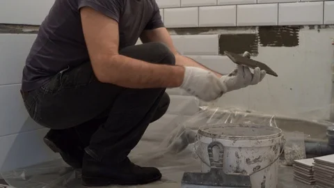 Application of tile glue on the tile Stock Footage 106435912