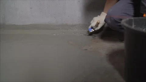 Application of waterproofing to the floor in the bathroom. Coated with Stock Footage 248667191