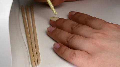 The application of yellow gel nail Polish.Drying in a UV lamp with LEDs. Stock-Footage 133226489