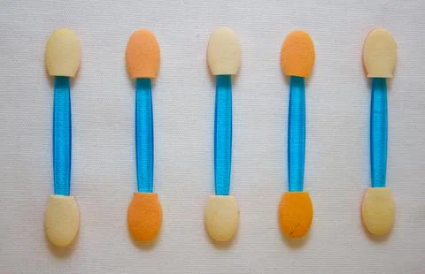 Applicators for eye make-up lie in a row on a white background. Applicators with Stock Photos