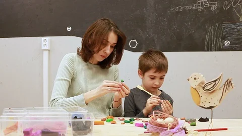 Applied arts lesson, plasticine modelling, child and teacher in the classroom Stock-Footage 102236454