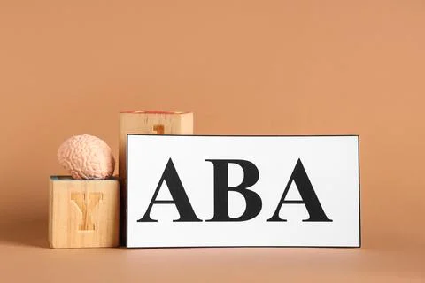 Applied behavior analysis with brain model and wooden blocks on neutral backg Stock Photos