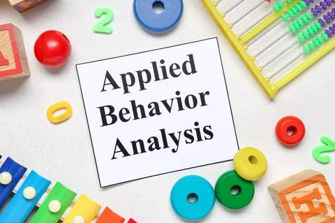 Applied behavior analysis text on paper with colorful childrens toys educatio Stock Photos