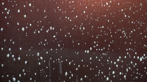 The applied foam on the car to remove dirt flows down closeup. Special detergent Stock Footage 129750350