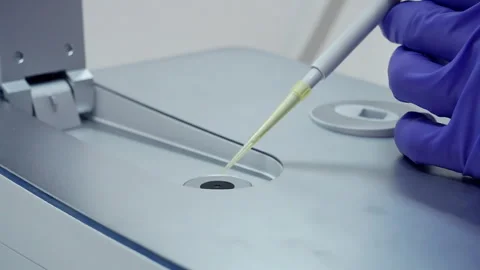 Applies a drop of liquid with DNA to the sensor Stock Footage 241103505