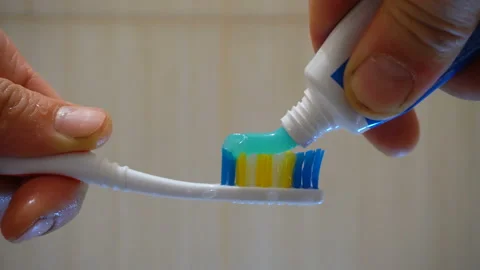 Apply blue toothpaste to the brush 4K Video stock 147894675