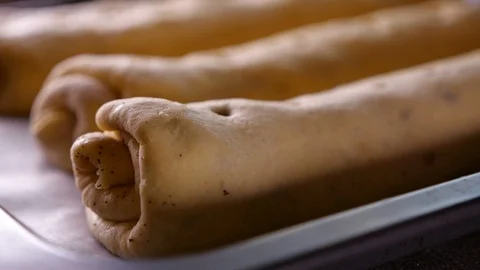 Apply egg white glaze on wallnut roll cake - extreme closeup Stock Footage 101632596