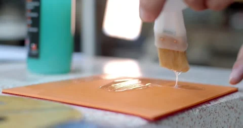 Apply glue onto the ping pong rubber. Stock Footage 277843748