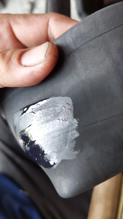 Apply glue to prepare for tire patching. Stock-Footage 293277188