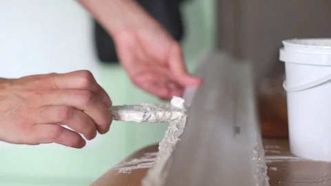 Apply glue to the skirting Board Stock Footage 116706636